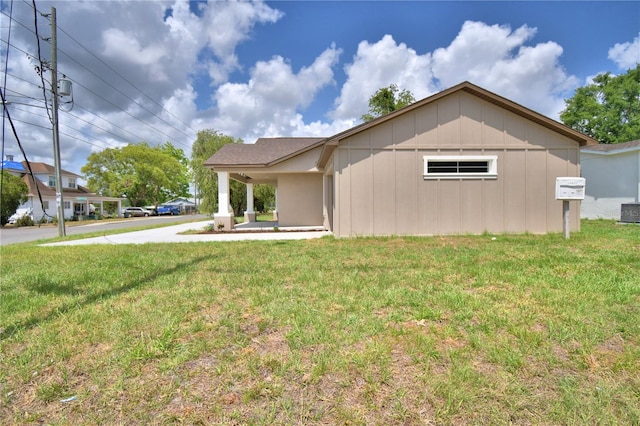 view of front of house with a front lawn and board and batten siding