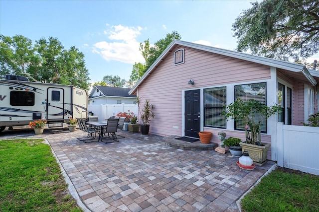 view of patio with fence and outdoor dining space