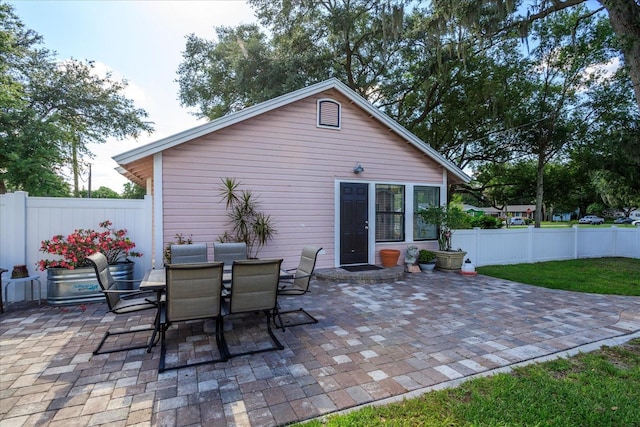 view of patio with fence and outdoor dining space