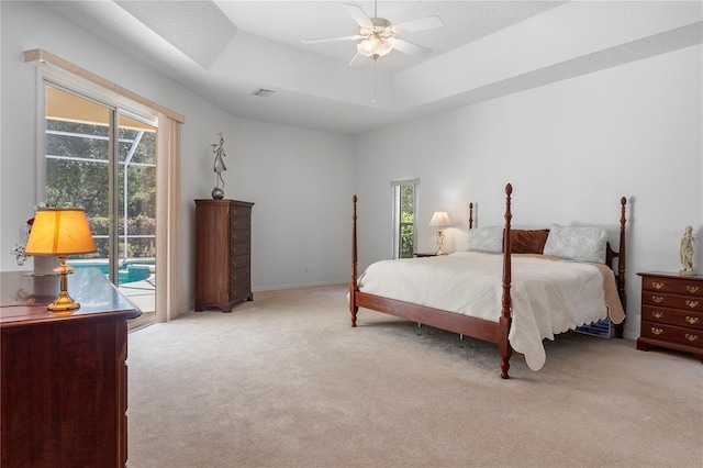 bedroom with carpet floors, multiple windows, and access to exterior
