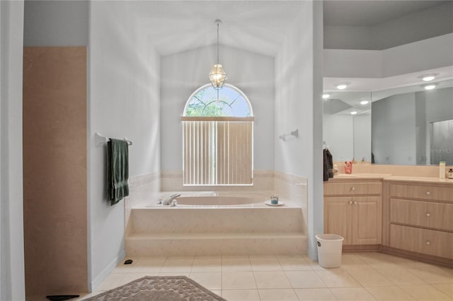 full bathroom with tile patterned flooring, a bath, lofted ceiling, and vanity