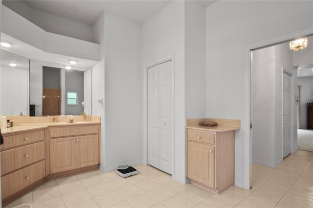 full bathroom with a closet, baseboards, tile patterned flooring, and vanity