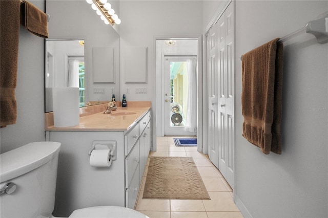 bathroom featuring vanity, tile patterned flooring, and toilet