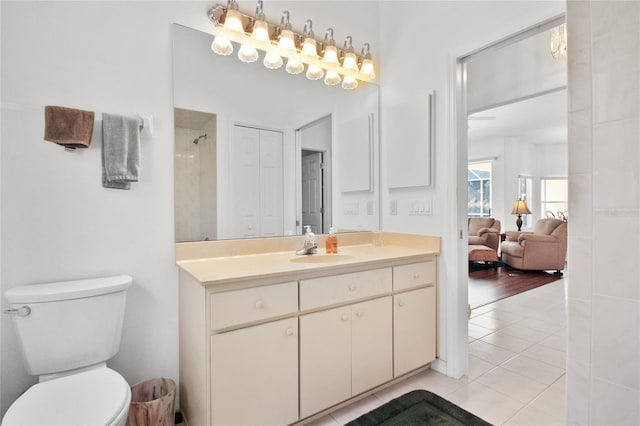 bathroom with toilet, tile patterned flooring, and vanity