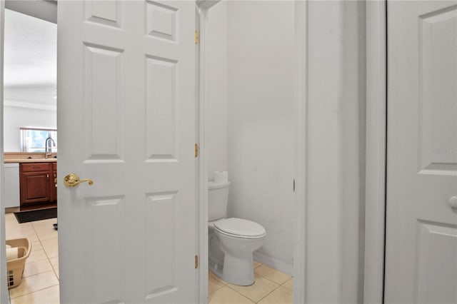 bathroom with a sink, tile patterned floors, and toilet