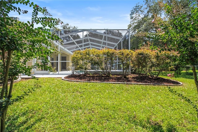 view of yard featuring glass enclosure