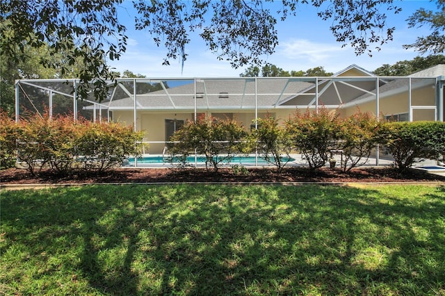 view of yard featuring a lanai and an outdoor pool