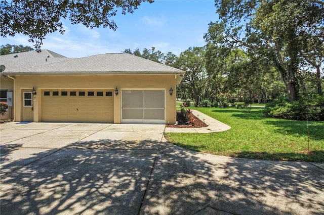 view of side of property with a lawn, stucco siding, driveway, and a garage