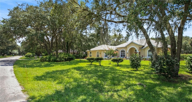 single story home with a front lawn and stucco siding