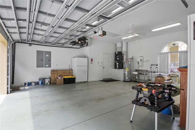 garage featuring electric panel, freestanding refrigerator, water heater, heating unit, and a garage door opener