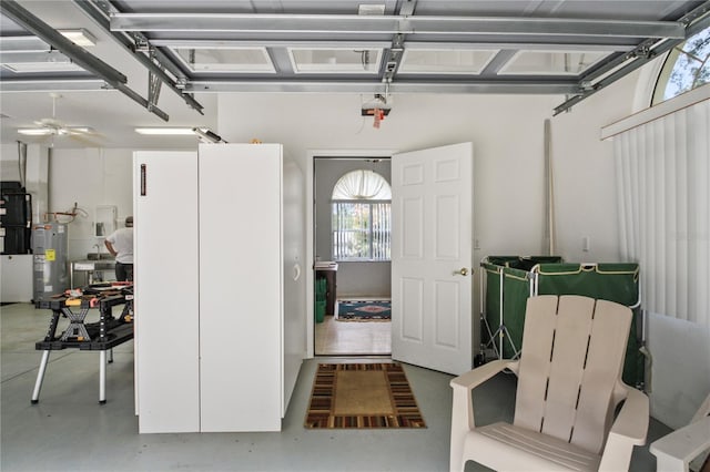 garage featuring water heater and a ceiling fan