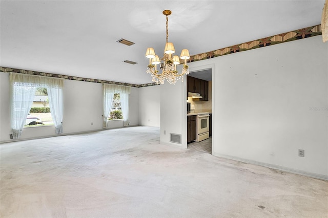 unfurnished living room featuring visible vents, a chandelier, and light colored carpet