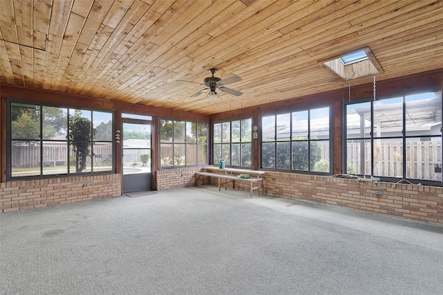 unfurnished sunroom with plenty of natural light, ceiling fan, and a skylight