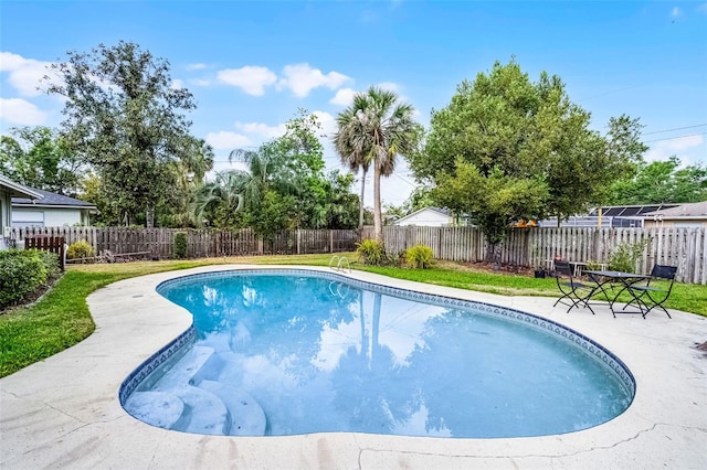 view of swimming pool featuring a fenced in pool, a fenced backyard, a patio area, and a yard