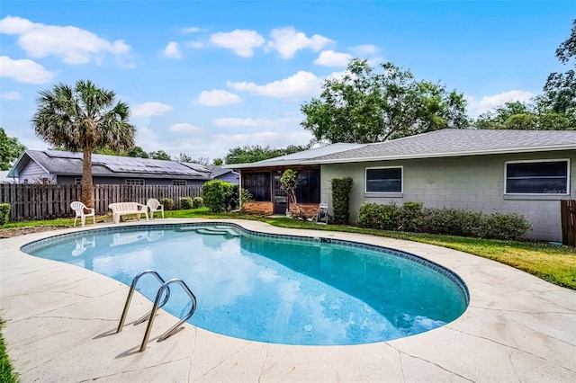 view of swimming pool with fence and a fenced in pool