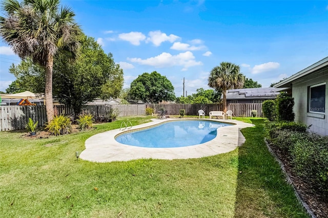 view of swimming pool with a yard, a fenced in pool, and a fenced backyard