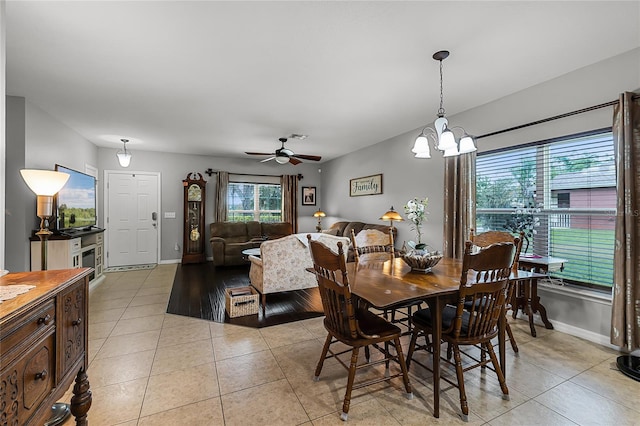 913 Bending Oak Trl, Winter Garden, FL 34787 - dining area with light tile patterned floors, baseboards, a chandelier, and a ceiling fan