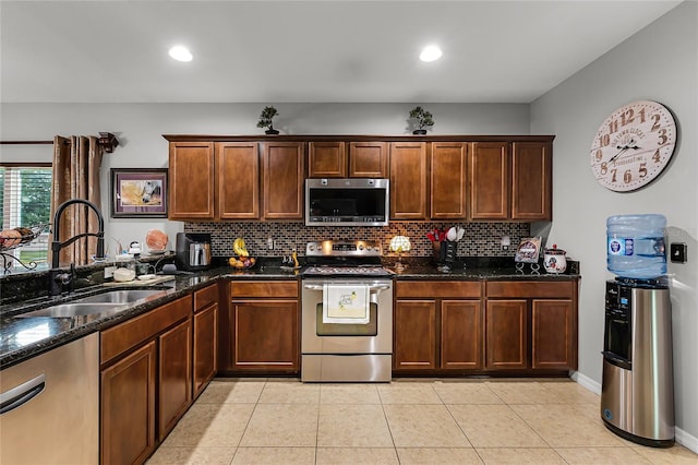 913 Bending Oak Trl, Winter Garden, FL 34787 - kitchen featuring appliances with stainless steel finishes, a sink, backsplash, dark stone countertops, and recessed lighting
