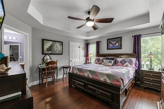 913 Bending Oak Trl, Winter Garden, FL 34787 - bedroom with a raised ceiling, dark wood-style floors, baseboards, and a ceiling fan