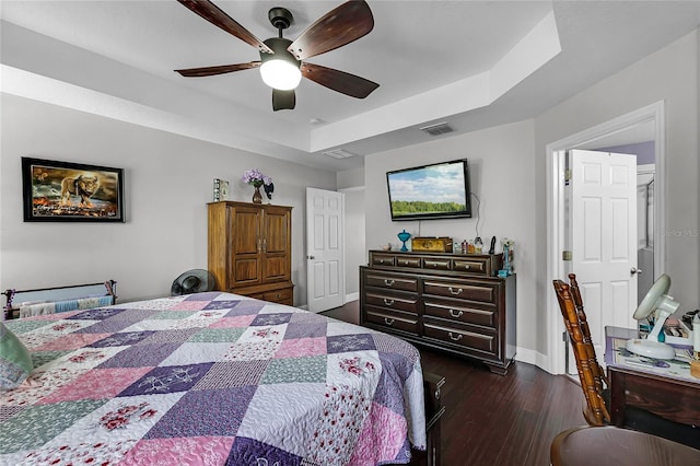 913 Bending Oak Trl, Winter Garden, FL 34787 - bedroom featuring dark wood finished floors, a tray ceiling, baseboards, and ceiling fan