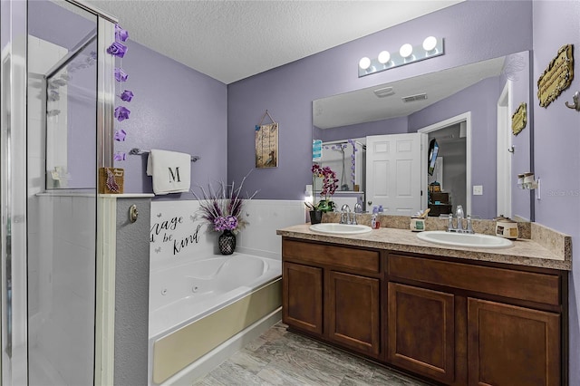 913 Bending Oak Trl, Winter Garden, FL 34787 - full bathroom with a shower stall, a tub with jets, double vanity, and a textured ceiling
