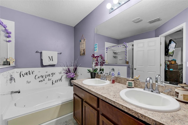 913 Bending Oak Trl, Winter Garden, FL 34787 - bathroom with a stall shower, a jetted tub, double vanity, and a textured ceiling