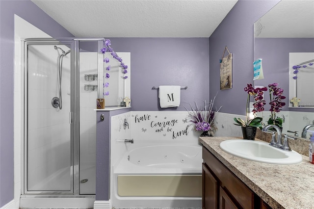 913 Bending Oak Trl, Winter Garden, FL 34787 - full bathroom with a textured ceiling, a stall shower, a whirlpool tub, and vanity