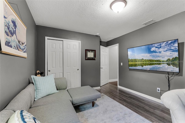 913 Bending Oak Trl, Winter Garden, FL 34787 - living room with wood finished floors, a textured ceiling, and baseboards
