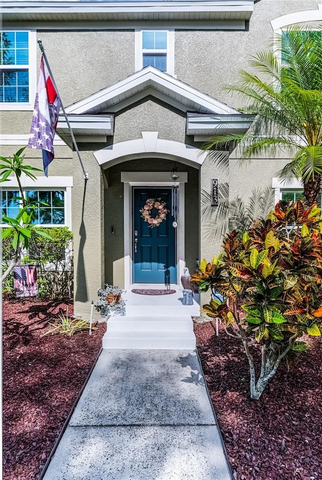 913 Bending Oak Trl, Winter Garden, FL 34787 - doorway to property with stucco siding