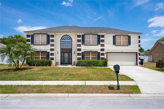 114 Shaddock Dr, Auburndale, FL 33823 - view of front facade featuring an attached garage, driveway, stucco siding, and a front yard