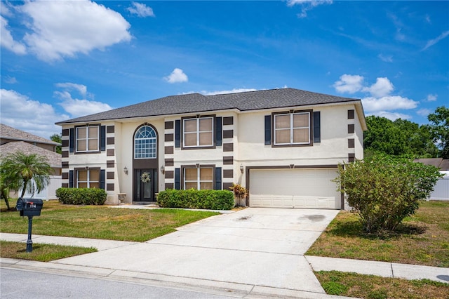 114 Shaddock Dr, Auburndale, FL 33823 - view of front facade featuring an attached garage, driveway, stucco siding, and a front yard