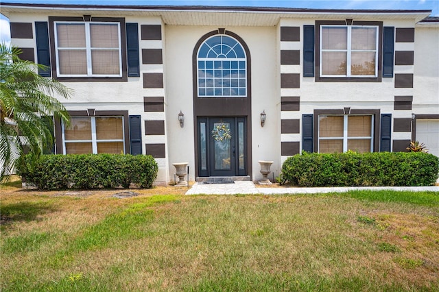 114 Shaddock Dr, Auburndale, FL 33823 - view of property featuring stucco siding and a front yard