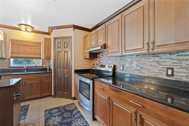 114 Shaddock Dr, Auburndale, FL 33823 - kitchen with stainless steel range with electric cooktop, a sink, light tile patterned floors, tasteful backsplash, and under cabinet range hood