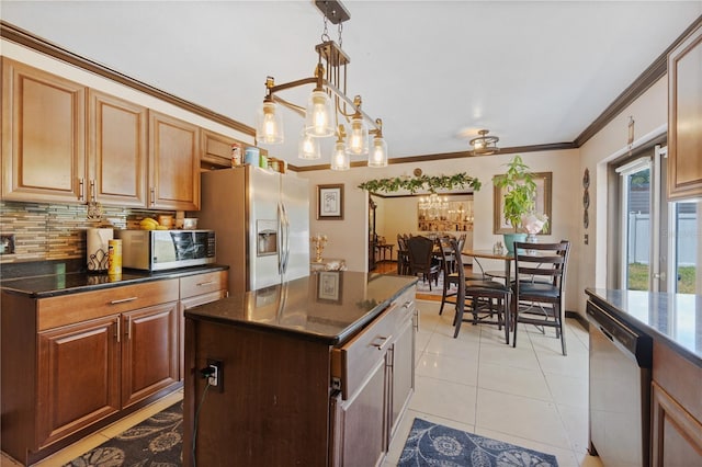 114 Shaddock Dr, Auburndale, FL 33823 - kitchen with decorative backsplash, appliances with stainless steel finishes, a center island, ornamental molding, and light tile patterned flooring