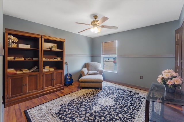 114 Shaddock Dr, Auburndale, FL 33823 - sitting room featuring baseboards, ceiling fan, and wood finished floors