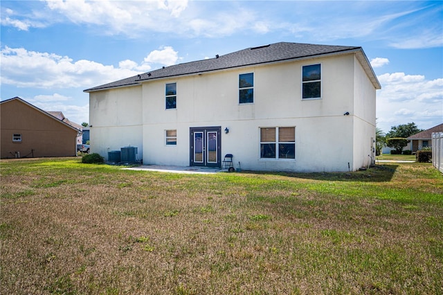 114 Shaddock Dr, Auburndale, FL 33823 - rear view of house featuring a lawn, a patio, french doors, and central AC unit