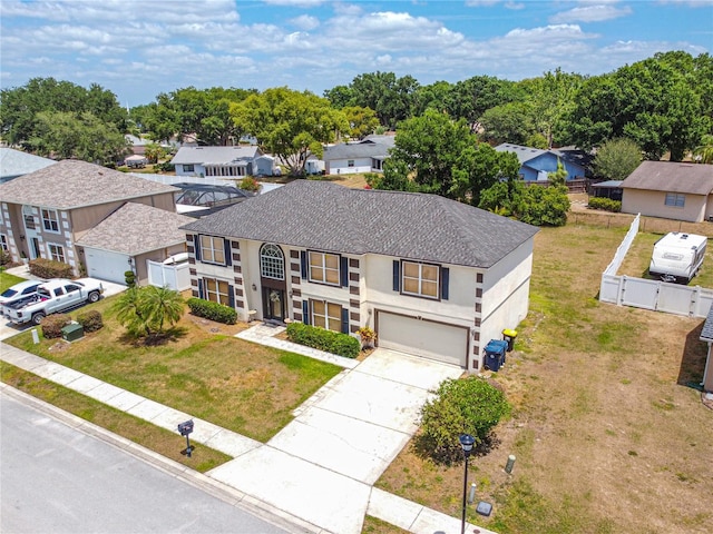 114 Shaddock Dr, Auburndale, FL 33823 - view of front facade featuring a residential view, an attached garage, and concrete driveway