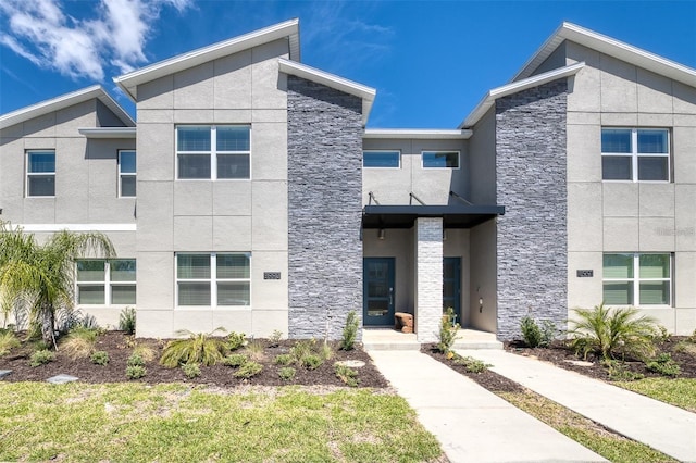 modern home with stucco siding and stone siding