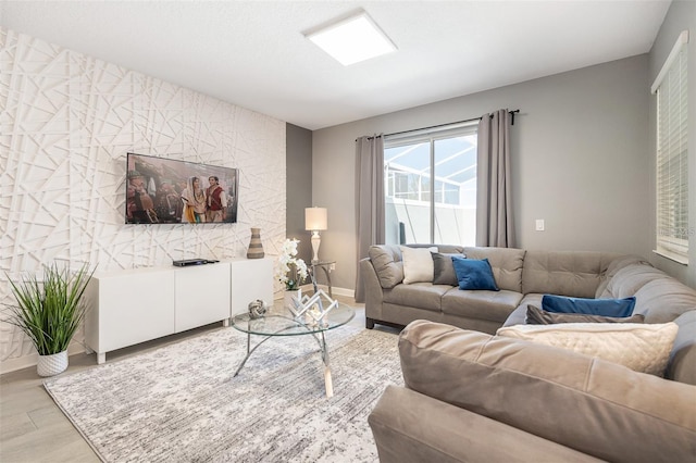 living room with baseboards and light wood-type flooring