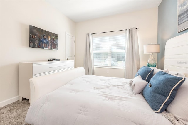 bedroom featuring baseboards and carpet
