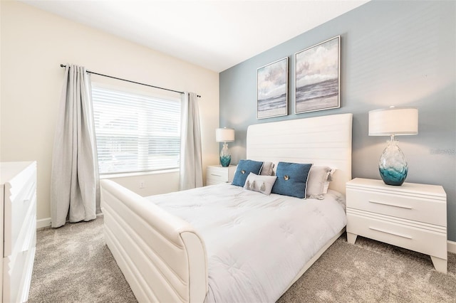 carpeted bedroom featuring baseboards