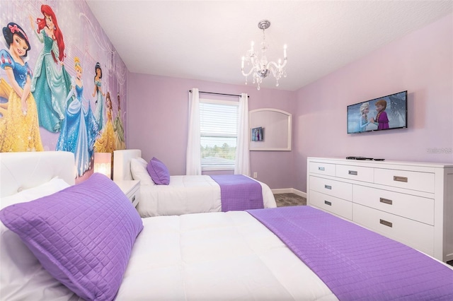 bedroom with baseboards, carpet, and a notable chandelier