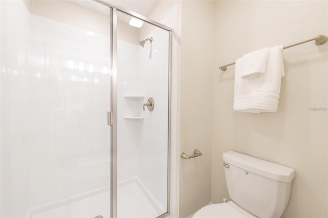full bath featuring toilet and a shower stall