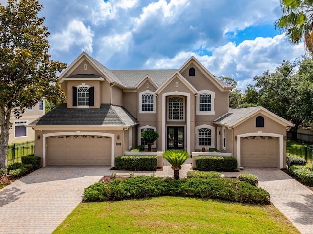14003 Hampshire Bay Cir, Winter Garden, FL 34787 - view of front facade featuring fence, stucco siding, and decorative driveway
