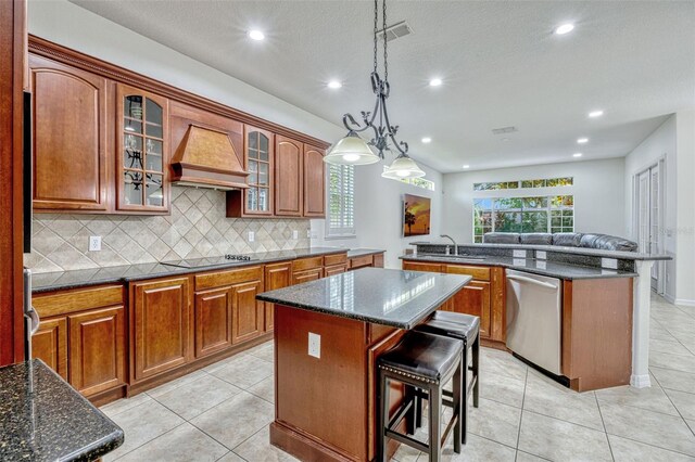 14003 Hampshire Bay Cir, Winter Garden, FL 34787 - kitchen featuring a center island, stainless steel dishwasher, black electric cooktop, a sink, and premium range hood