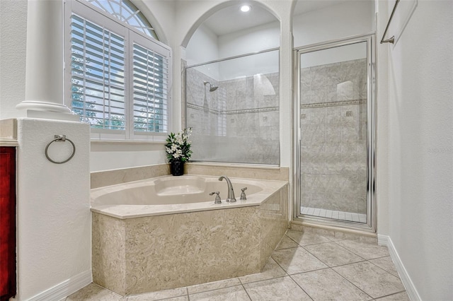 14003 Hampshire Bay Cir, Winter Garden, FL 34787 - bathroom with tile patterned flooring, a bath, and a stall shower