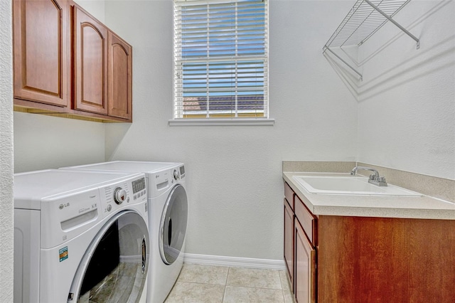 14003 Hampshire Bay Cir, Winter Garden, FL 34787 - laundry area featuring baseboards, separate washer and dryer, a sink, cabinet space, and light tile patterned floors