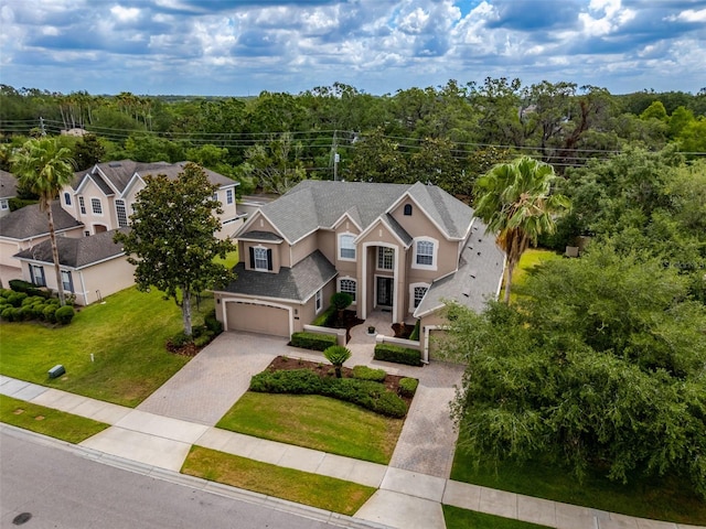 14003 Hampshire Bay Cir, Winter Garden, FL 34787 - view of front facade with a garage, stucco siding, driveway, and a front yard