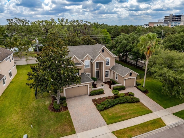 14003 Hampshire Bay Cir, Winter Garden, FL 34787 - view of front of home featuring stucco siding, a front lawn, and decorative driveway