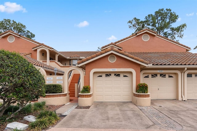 7449 Sugar Bend Dr Unit 7449, Orlando, FL 32819 - mediterranean / spanish house with stucco siding, concrete driveway, and a tiled roof